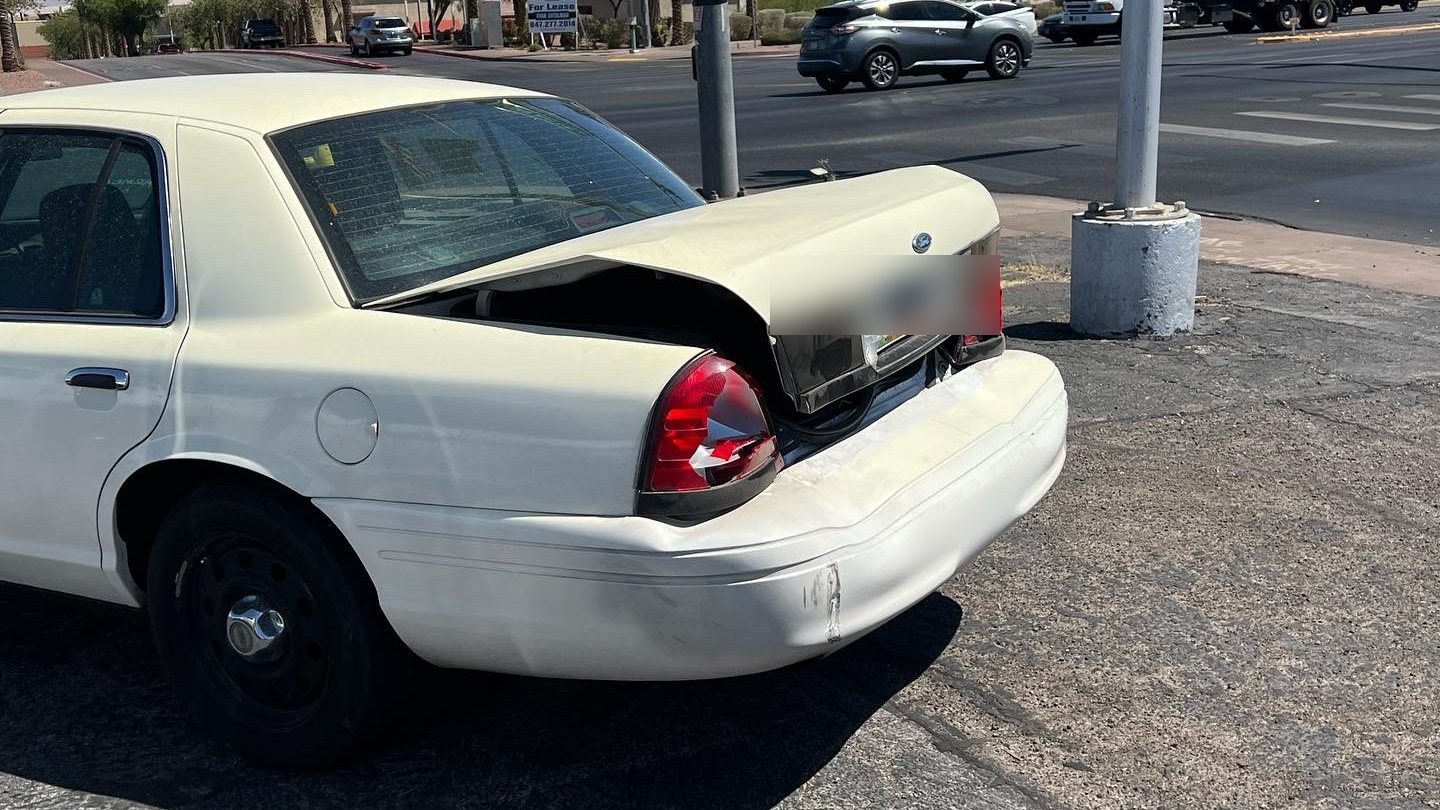 Before: Ford Crown Victoria with rear-end collision damage, crumpled trunk lid
